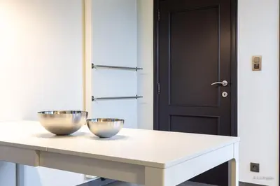 a kitchen with two bowls on a table with a door at 14 beds, 20p, 2 bath-, 1 livingroom in Houthalen-Helchteren