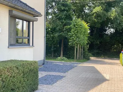 a house with a walkway next to a building at 14 beds, 20p, 2 bath-, 1 livingroom in Houthalen-Helchteren