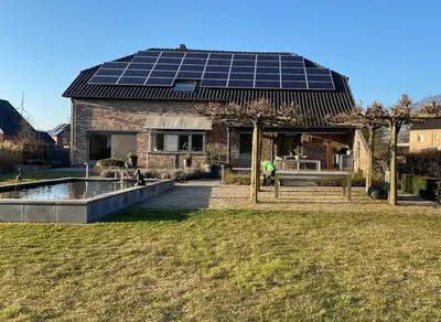 a house with solar panels on the roof at Het Kabinet in Munsterbilzen