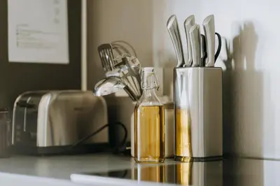 a counter top with a bottle of oil and utensils at 1 bedroom apartment in Liège center, Place du Marche - 3rd floor in Liège