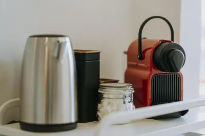 a counter with a coffee maker and a thermos at 1 bedroom apartment in Liège center, Place du Marche - 3rd floor in Liège