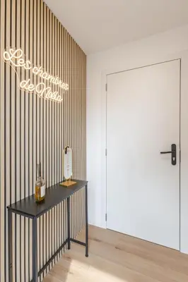 a room with a table with a bottle of wine at LoveRoom avec balnéo privative in Flémalle-Grande