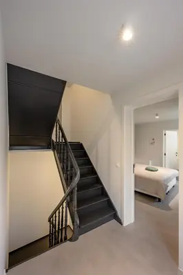 a staircase leading to a bedroom in a house at Borgraaf - Fruitzicht in Borgloon