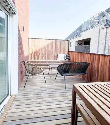 a patio with two chairs and a table on a balcony at Borgraaf - Fruitzicht in Borgloon
