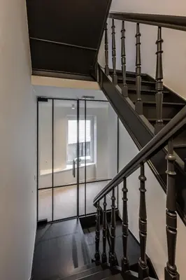 a staircase with a glass door in a building at Borgraaf - Fruitzicht in Borgloon