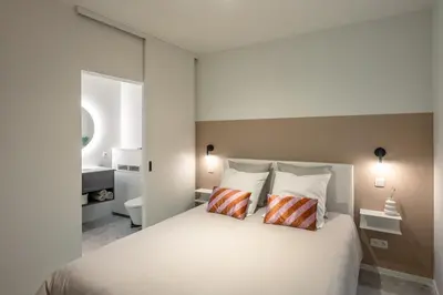 a bedroom with a white bed with two pillows at Borgraaf - Palazzio in Borgloon
