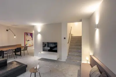 a living room with a couch and a fireplace at Borgraaf - Palazzio in Borgloon
