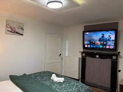 a bedroom with a bed and a flat screen tv at 3 Bedrooms budget appartement in Heers