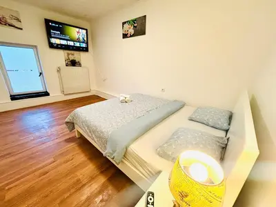 a bedroom with a bed and a tv on the wall at 3 Bedrooms budget appartement in Heers