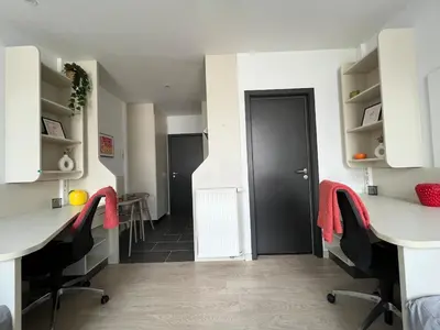a room with two desks and a black door at Le spot Central securisé sauna rooftop in Liège
