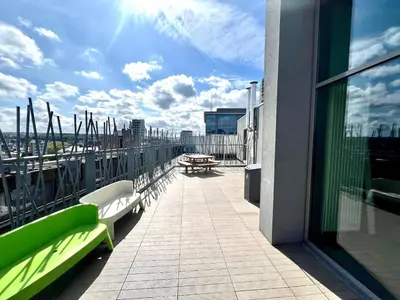 a balcony with benches and a view of a city at Le spot Central securisé sauna rooftop in Liège