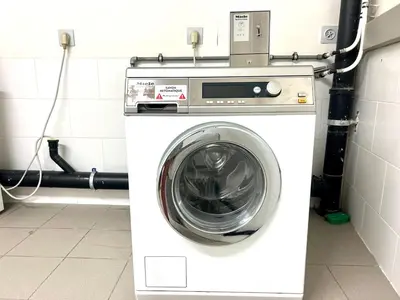 a white washing machine in a room with at Le spot Central securisé sauna rooftop in Liège