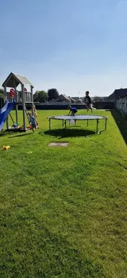 a person jumping on a picnic table in a park at Basecamp18 in Lommel