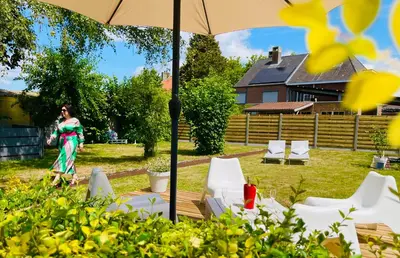 a woman standing under an umbrella in a yard at BEEEP Stay in Hasselt