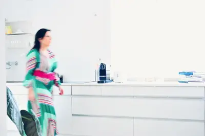 a woman is walking in a kitchen at BEEEP Stay in Hasselt