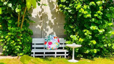 a bench with a pillow sitting next to a table at BEEEP Stay in Hasselt