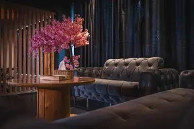 a room with couches and a table with pink flowers at Loft Ardent in Liège