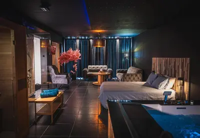 a bedroom with a bed and a living room at Loft Ardent in Liège