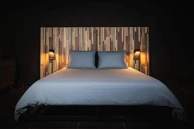 a bedroom with a large bed with two pillows at Loft Ardent in Liège