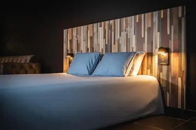a large bed with blue pillows in a room at Loft Ardent in Liège