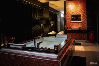 a bathroom with a bath tub with a sink at Le Gate One in Herbesthal