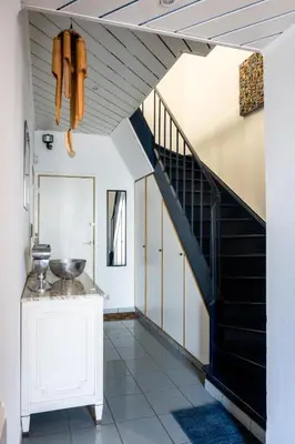 a hallway with a staircase in a house at Chez Marraine Suzanne in Liège
