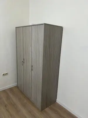 a wooden cabinet in the corner of a room at Maison sympa in Liège