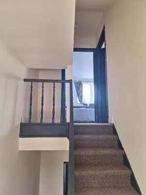a staircase in a house with a window at Maison sympa in Liège