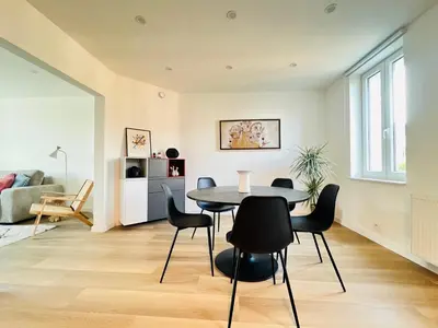 a dining room with a table and chairs at Le Cocon des Tilleuls - Duplex 2 Ch - Parking inclus au pied du logement ! in Liège