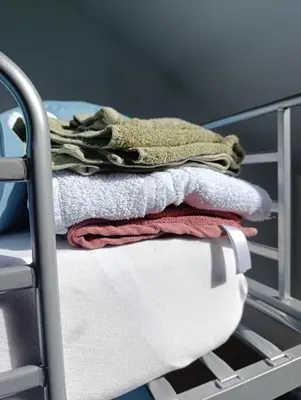 a pile of towels sitting on top of a crib at résidence KAKIKA in Verviers