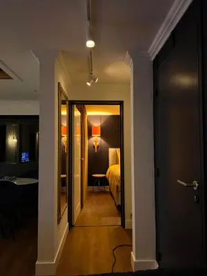 a hallway leading to a bedroom with a bed at Garden Street - Antiquity Blue in Lommel