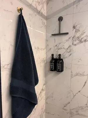 a black towel hanging on a wall in a bathroom at Garden Street - Antiquity Blue in Lommel