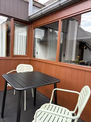 a black table and two white chairs on a patio at Garden Street - Antiquity Blue in Lommel