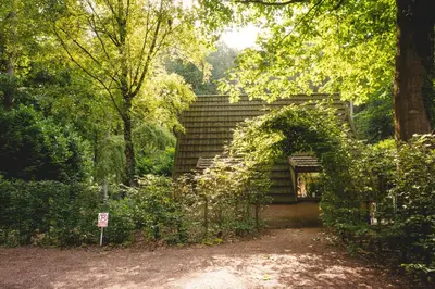 a brick building in the middle of a forest at Boshuisje Rekem - Kitoko in Lanaken