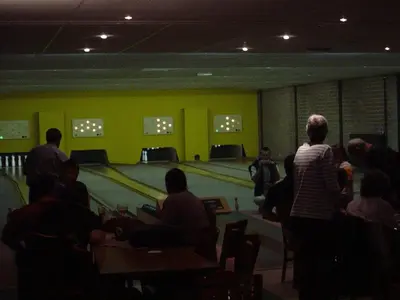 a group of people standing around a bowling alley at Hotel De Watermolen in Bocholt