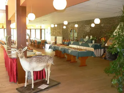 a deer statue standing on a table in a restaurant at Hotel De Watermolen in Bocholt