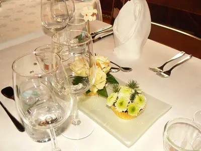a table with wine glasses and a plate with a cupcake at Hotel De Watermolen in Bocholt