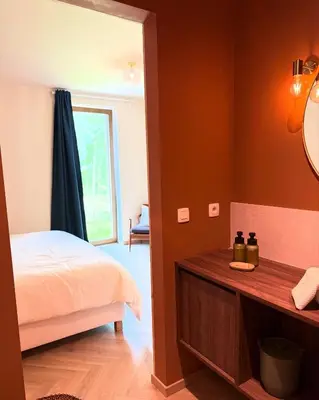 a bedroom with a bed and a mirror and a window at Zandberg11 in Bree