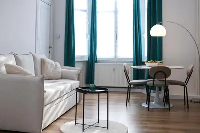 a living room with a couch and a table at Cozy Home Liege in Liège