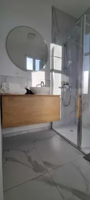 a bathroom with a sink and a mirror at Cozy Home Liege in Liège