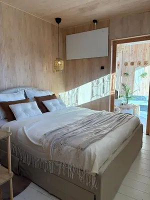 a bedroom with a large bed in a room at Wellness B&B Essential by Cin in Zonhoven