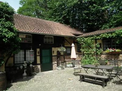 a house with a picnic table in front of it at Hof ter Wallen in Zoutleeuw