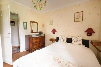 a bedroom with a bed and a dresser and a mirror at Hof ter Wallen in Zoutleeuw