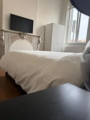 a bedroom with a bed with a tv on top of it at Luxury Riverfront Apartment near La Meuse in Liège