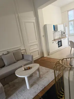 a living room with a couch and a table at Luxury Riverfront Apartment near La Meuse in Liège