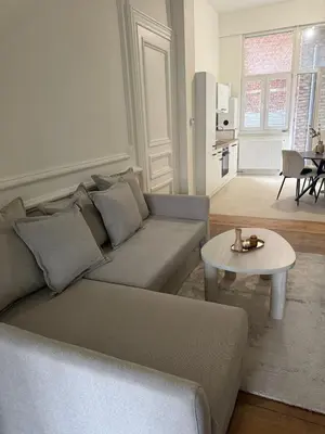a living room with a couch and a table at Luxury Riverfront Apartment near La Meuse in Liège