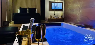 a hot tub with a bottle of wine in a bedroom at Luxury Loft Home Sweet House in Oupeye