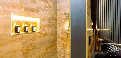 a bathroom with a shower with bottles of wine at Luxury Loft Home Sweet House in Oupeye