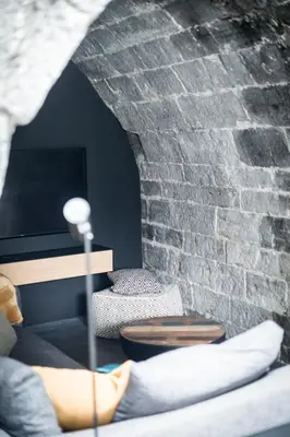 a living room with a brick wall and a couch at La Tour in Liège