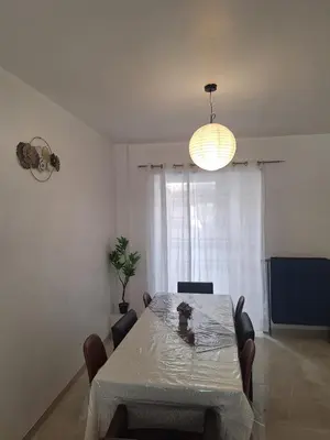 a dining room with a table and a light at Maison sympathique in Liège
